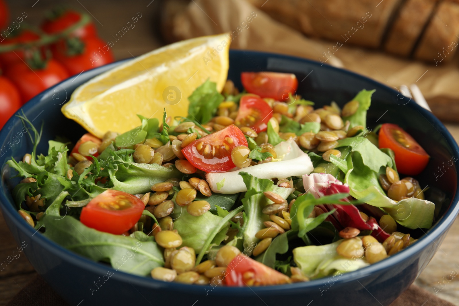 Photo of Delicious salad with lentils and vegetables on table, closeup