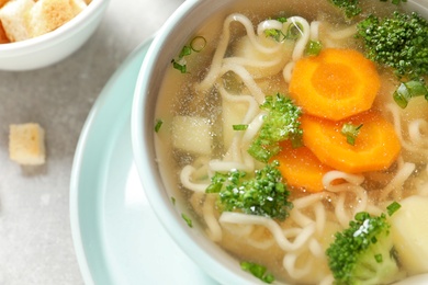 Bowl of fresh homemade vegetable soup on table, closeup