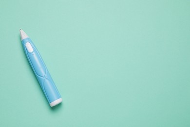Photo of Stylish 3D pen on turquoise background, top view. Space for text