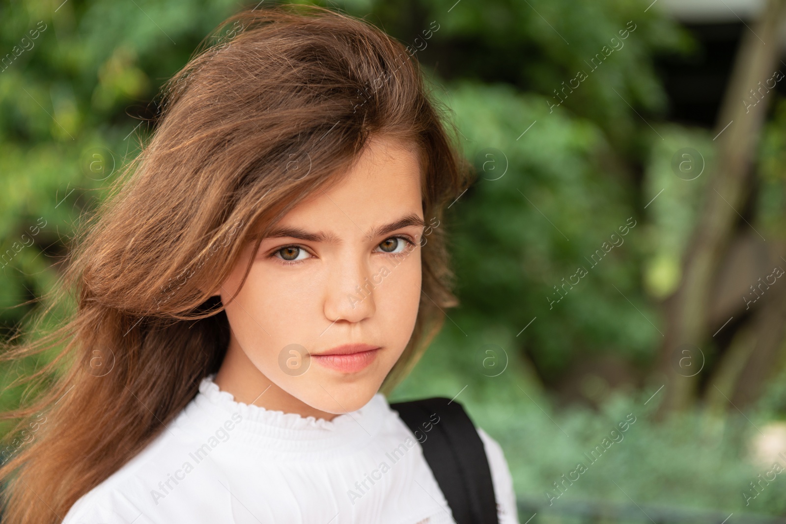 Photo of Portrait of teenage girl outdoors on sunny day, space for text