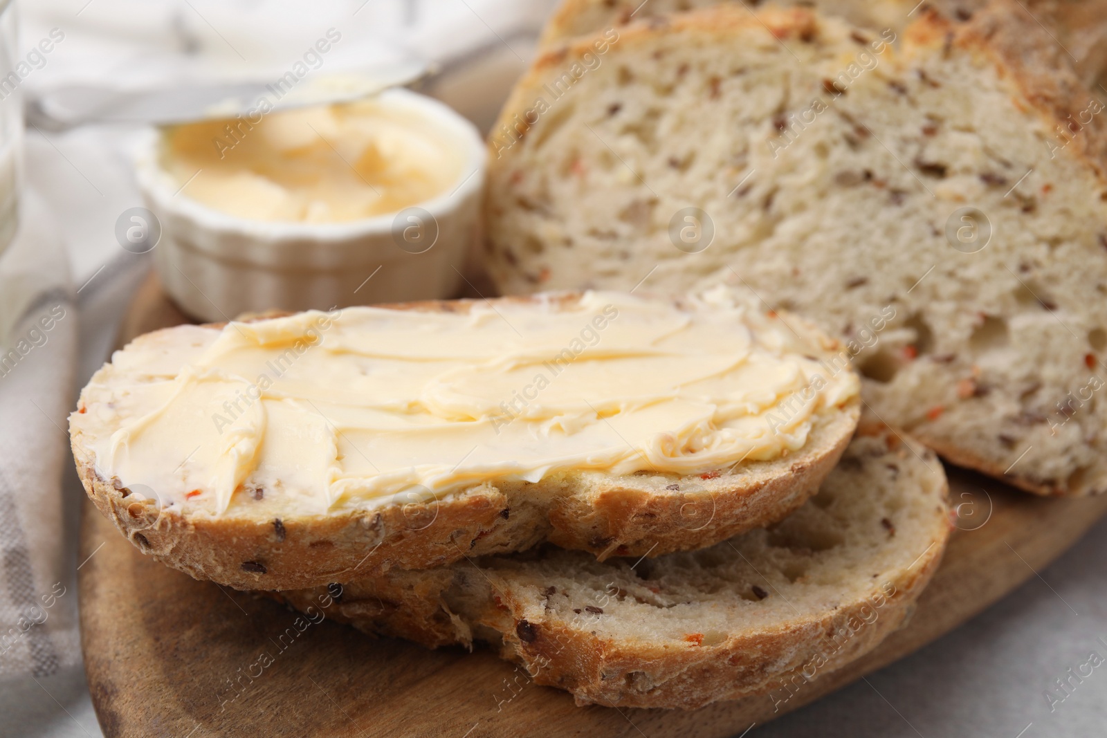 Photo of Tasty bread with butter on table, closeup