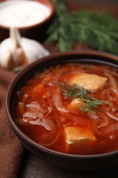 Bowl of delicious borscht on table, closeup