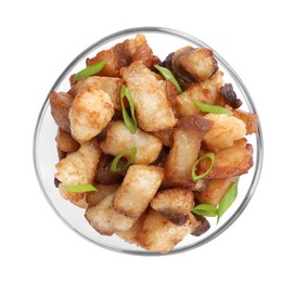 Photo of Tasty fried cracklings with green onion in bowl on white background, top view. Cooked pork lard