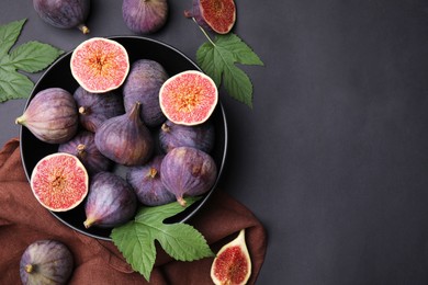 Photo of Fresh ripe purple figs on black table, flat lay. Space for text
