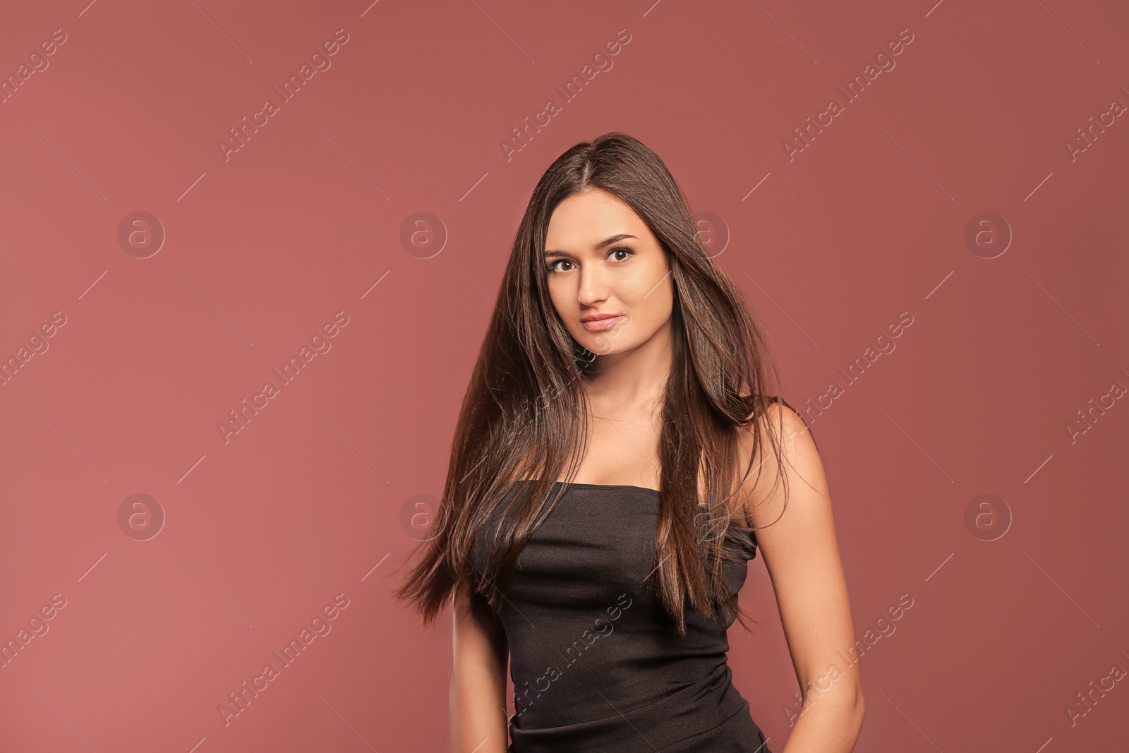 Photo of Portrait of beautiful model with gorgeous straight hair on color background