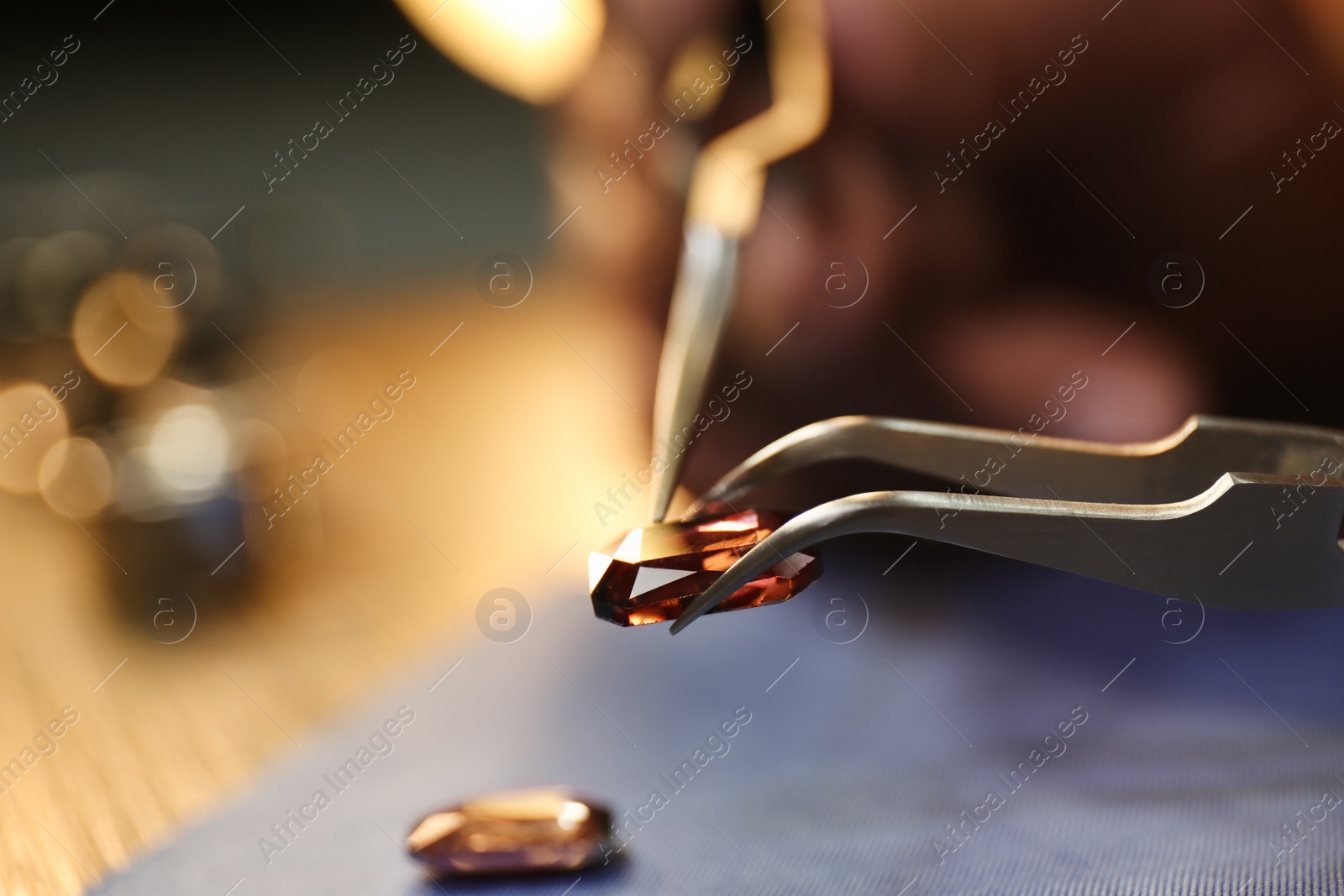 Photo of Beautiful gemstone in jeweler's workshop, closeup. Space for text