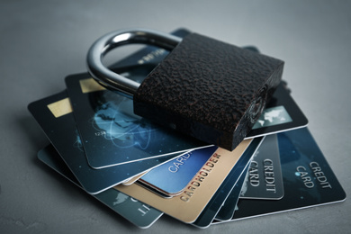 Photo of Credit cards and padlock on light grey background. Protection from cyber attack