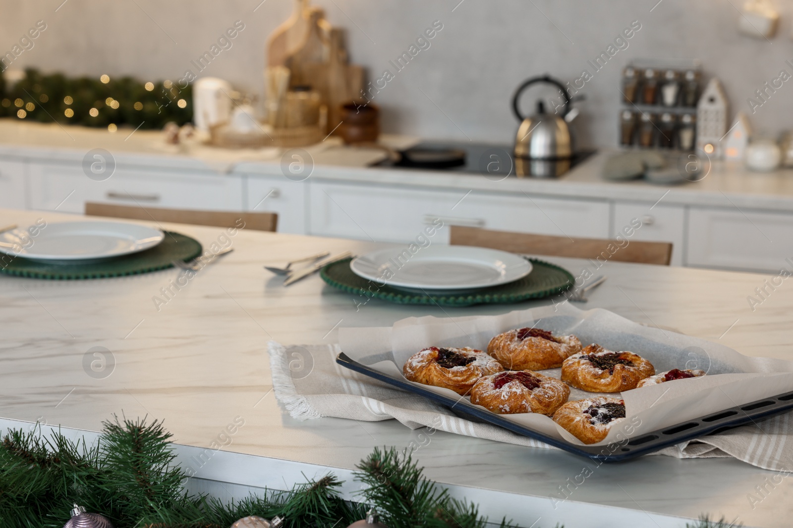 Photo of Tasty Christmas cookies on white marble table in kitchen