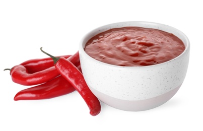 Photo of Bowl with red sauce and fresh chili peppers isolated on white