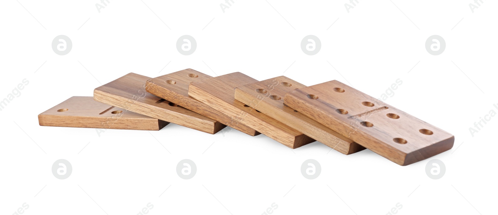 Photo of Fallen wooden domino tiles with pips isolated on white