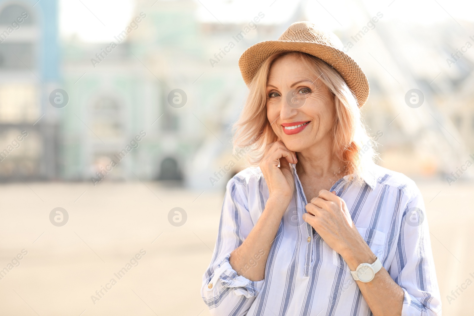 Photo of Portrait of happy mature woman on city street