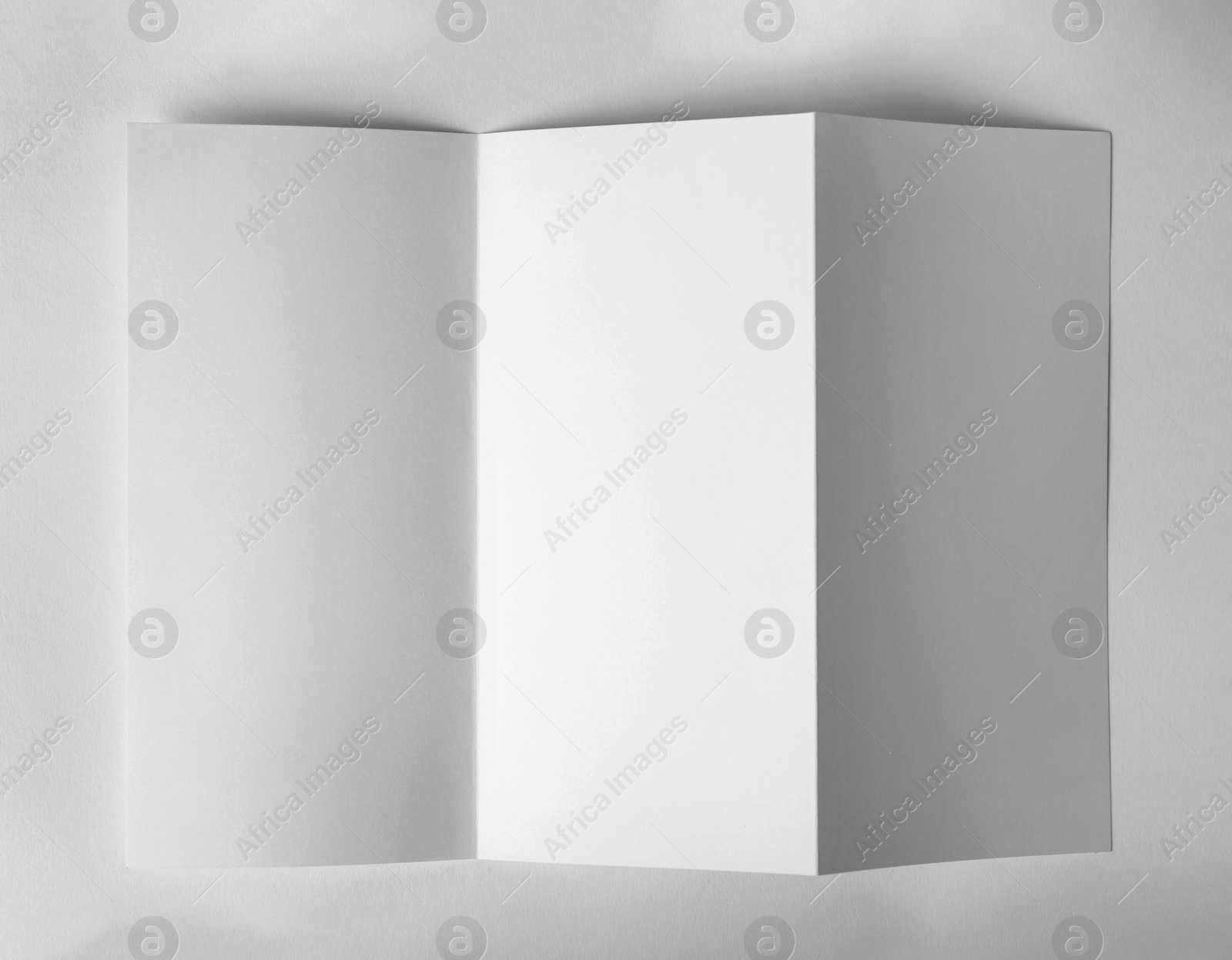 Photo of Blank brochure mock up on white background, top view