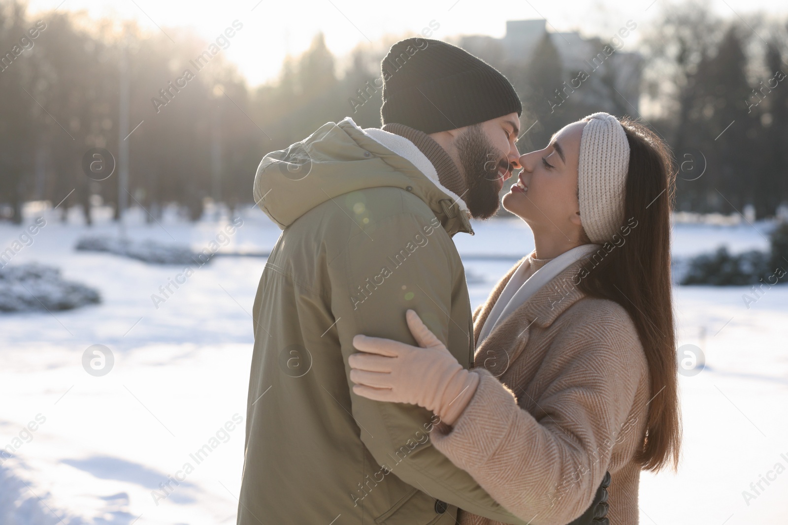 Photo of Beautiful happy couple in snowy park on winter day