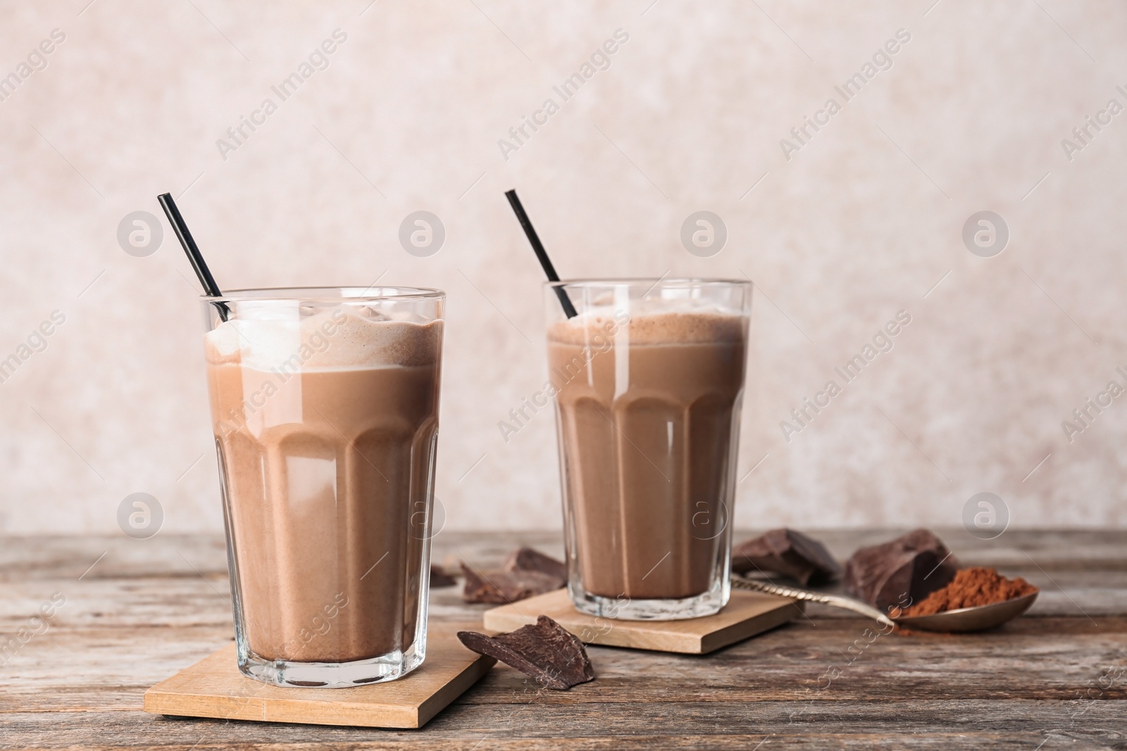 Photo of Glasses with chocolate milk shakes on wooden table