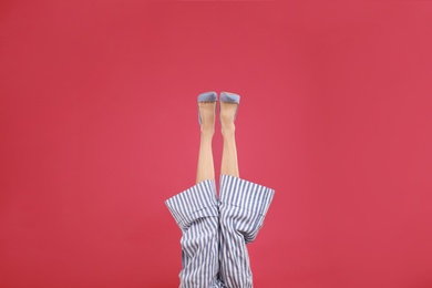 Photo of Woman in elegant shoes on crimson background