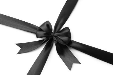 Photo of Black satin ribbon with bow isolated on white, top view
