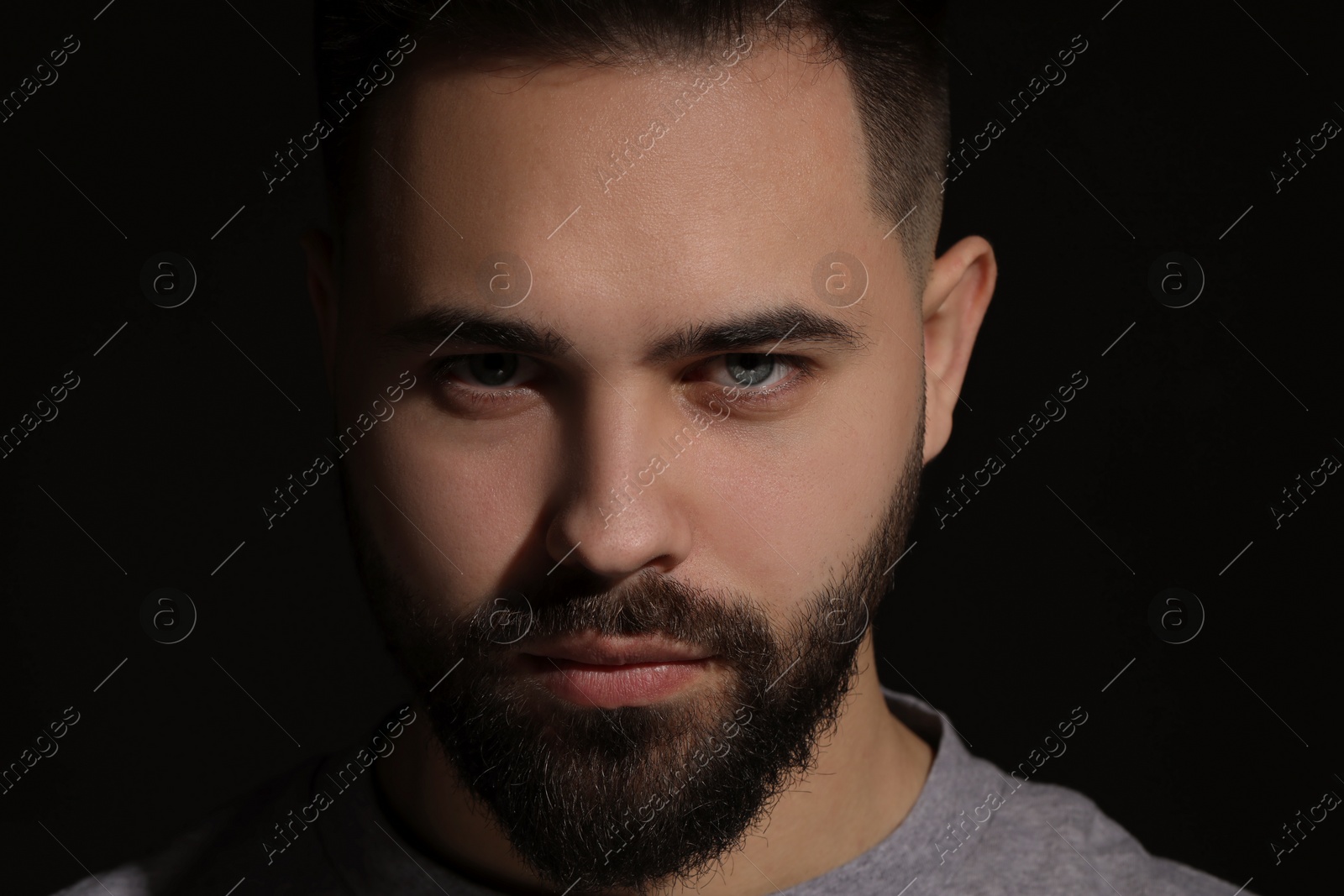 Photo of Evil eye. Man with scary eyes on black background