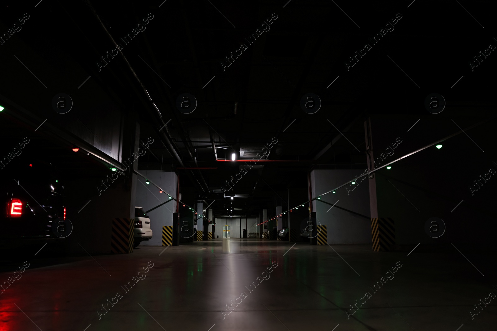 Photo of Modern parking garage with cars at night