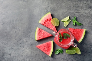 Photo of Summer watermelon drink in mason jar, sliced fruits and space for text on table, top view