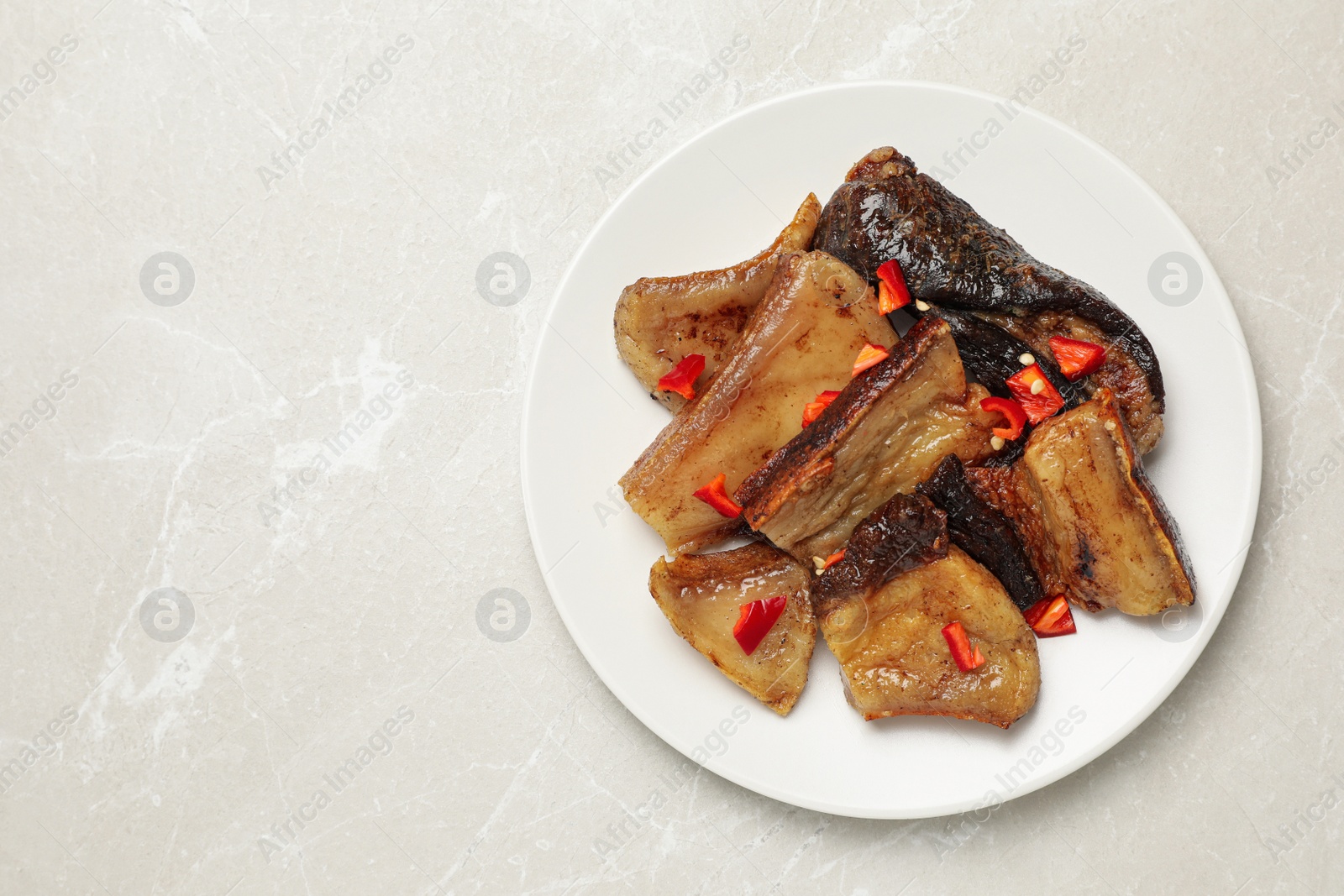 Photo of Tasty fried pork lard with pepper on light table, top view. Space for text