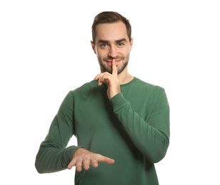 Photo of Man showing HUSH gesture in sign language on white background