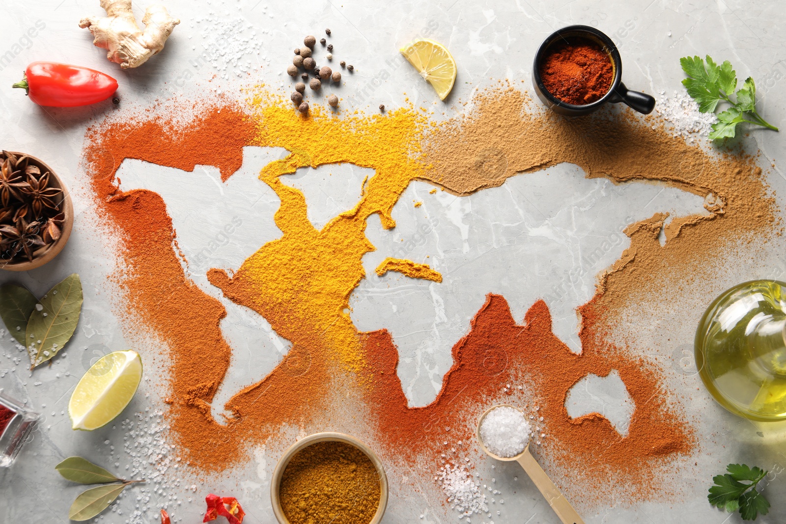 Photo of World map of different spices and products on light grey marble table, flat lay