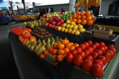 Photo of Tasty fresh fruits on counter at wholesale market