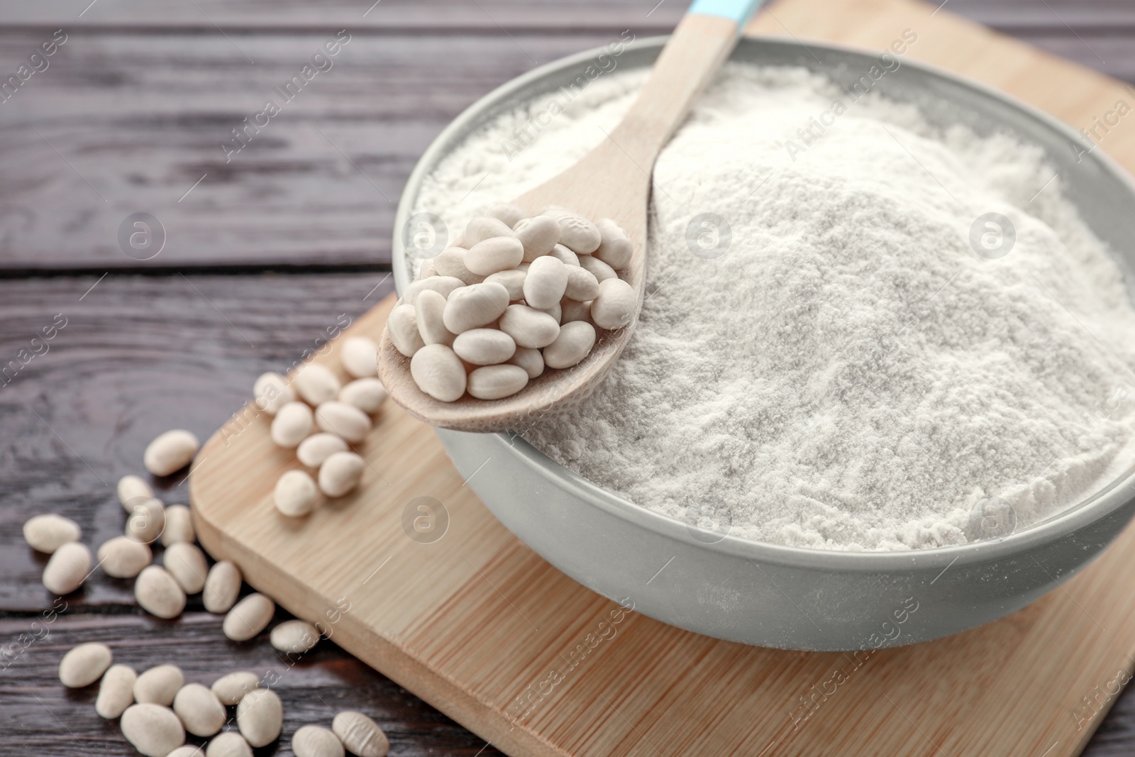 Photo of Kidney bean flour and seeds on wooden table, closeup