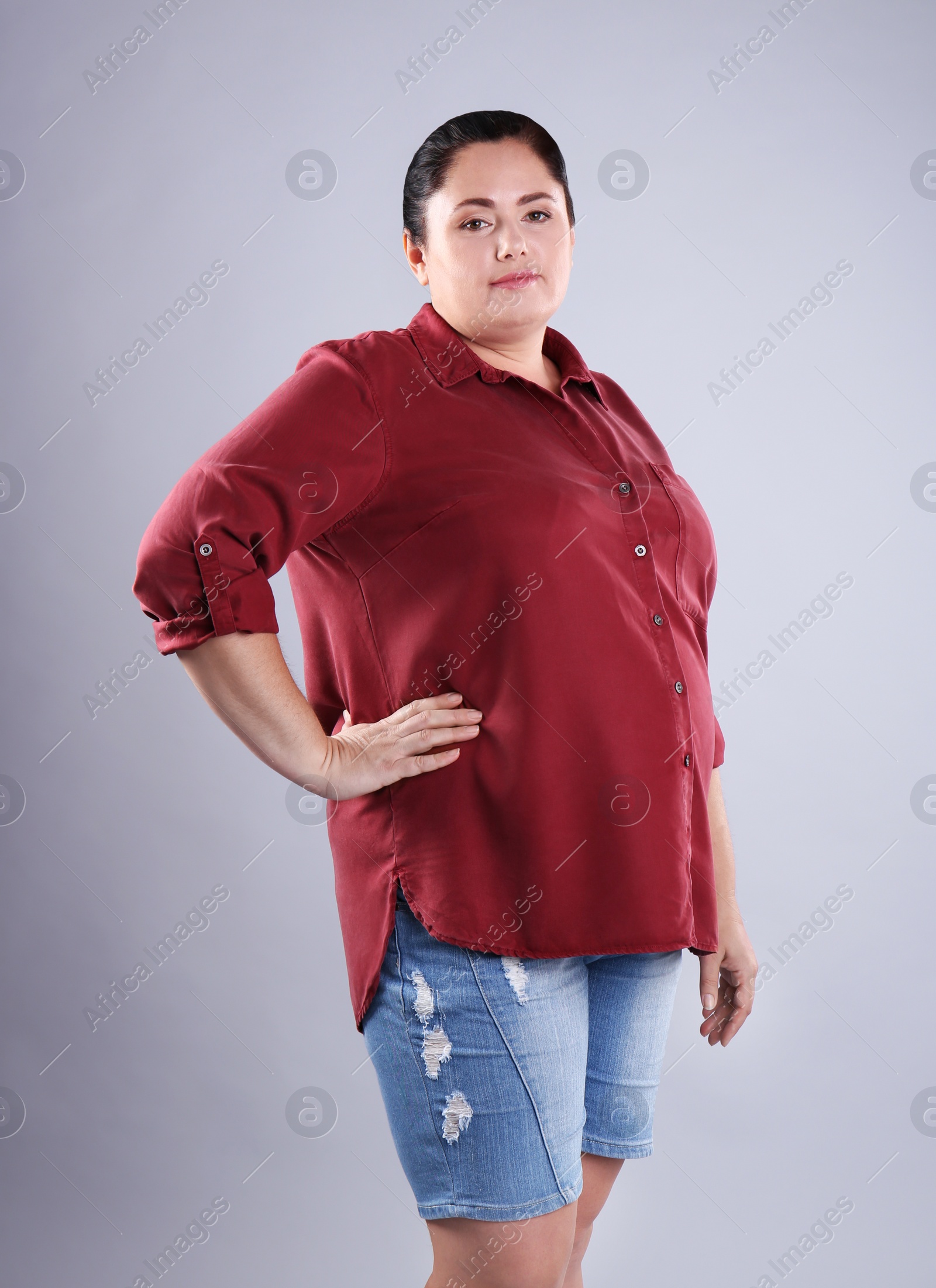 Photo of Fat woman on grey background. Weight loss