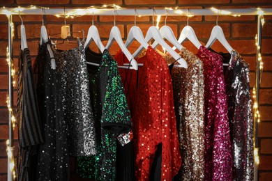 Photo of Collection of different beautiful women's party dresses in showroom. Stylish trendy clothes for high school prom