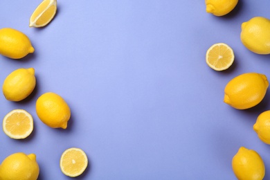 Photo of Flat lay composition with whole and sliced lemons on color background