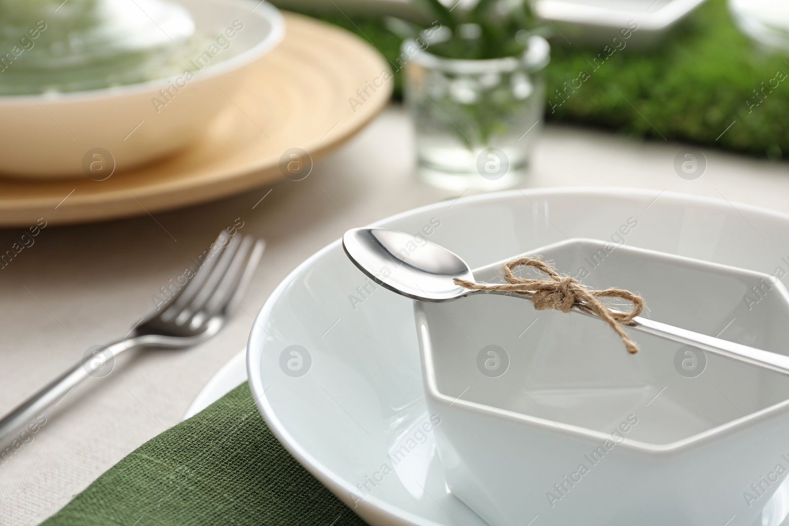 Photo of Stylish dishes with spoon on table, closeup. Festive setting