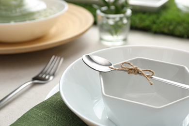 Stylish dishes with spoon on table, closeup. Festive setting