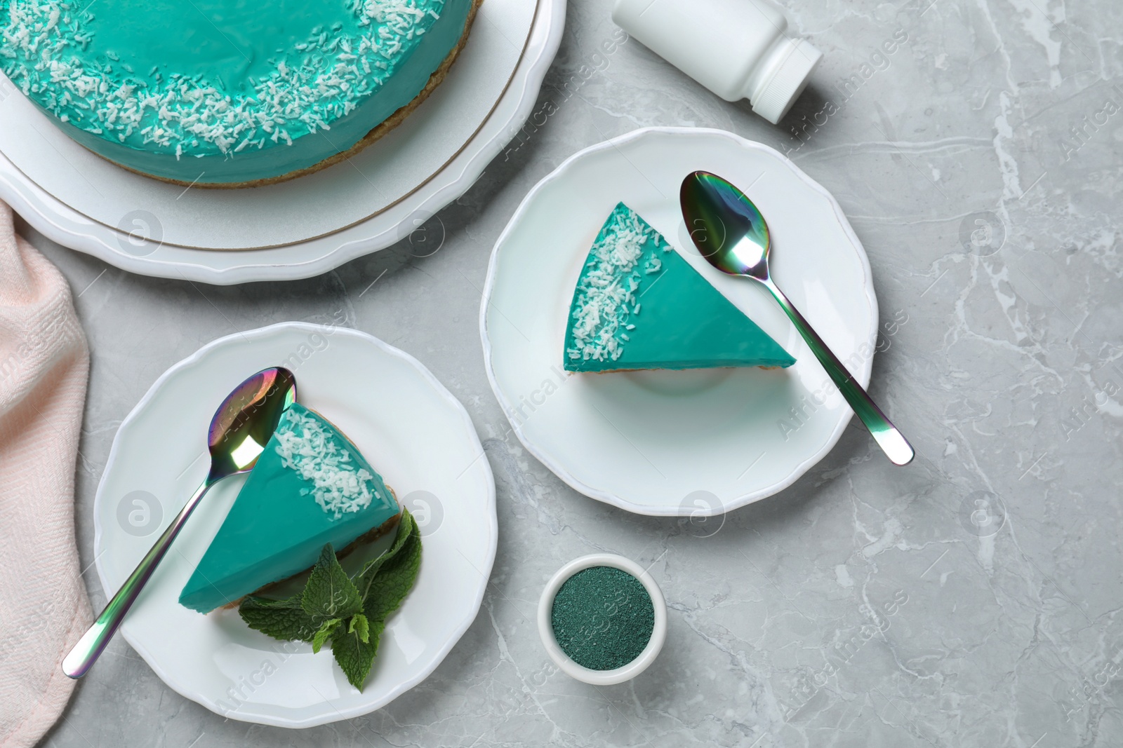 Photo of Flat lay composition with tasty spirulina cheesecake on grey table