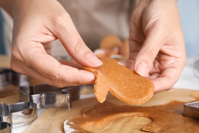 Photo of Woman making Christmas cookies at table, closeup