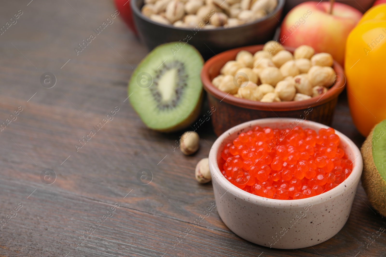 Photo of Many different products on wooden table, closeup and space for text. Natural sources of serotonin