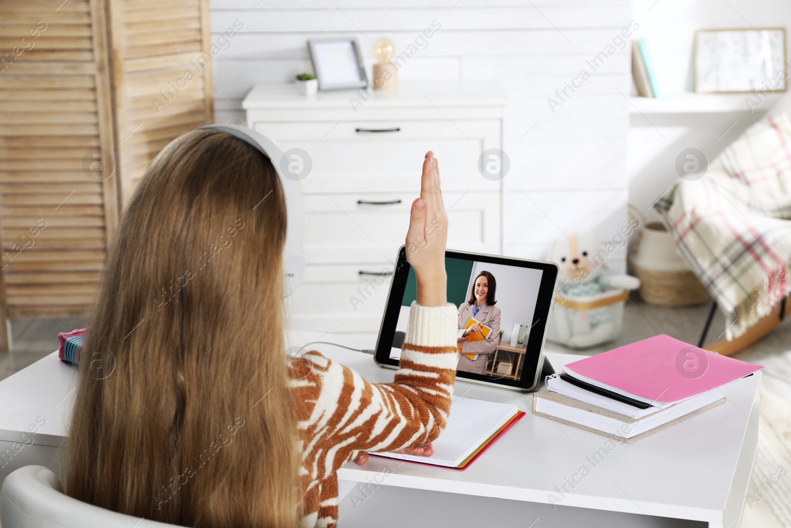 Image of Cute little girl with modern tablet at online lesson. E-learning