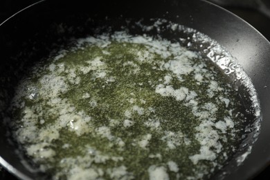 Photo of Melting butter in frying pan, closeup view