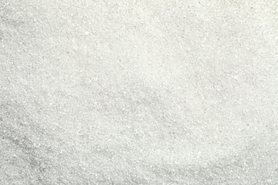 Pile of granulated sugar as background, top view