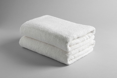 Fresh soft folded towels on light background