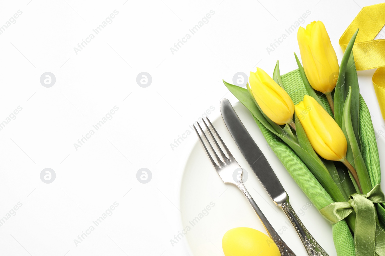 Photo of Festive Easter table setting with floral decor on white background, top view