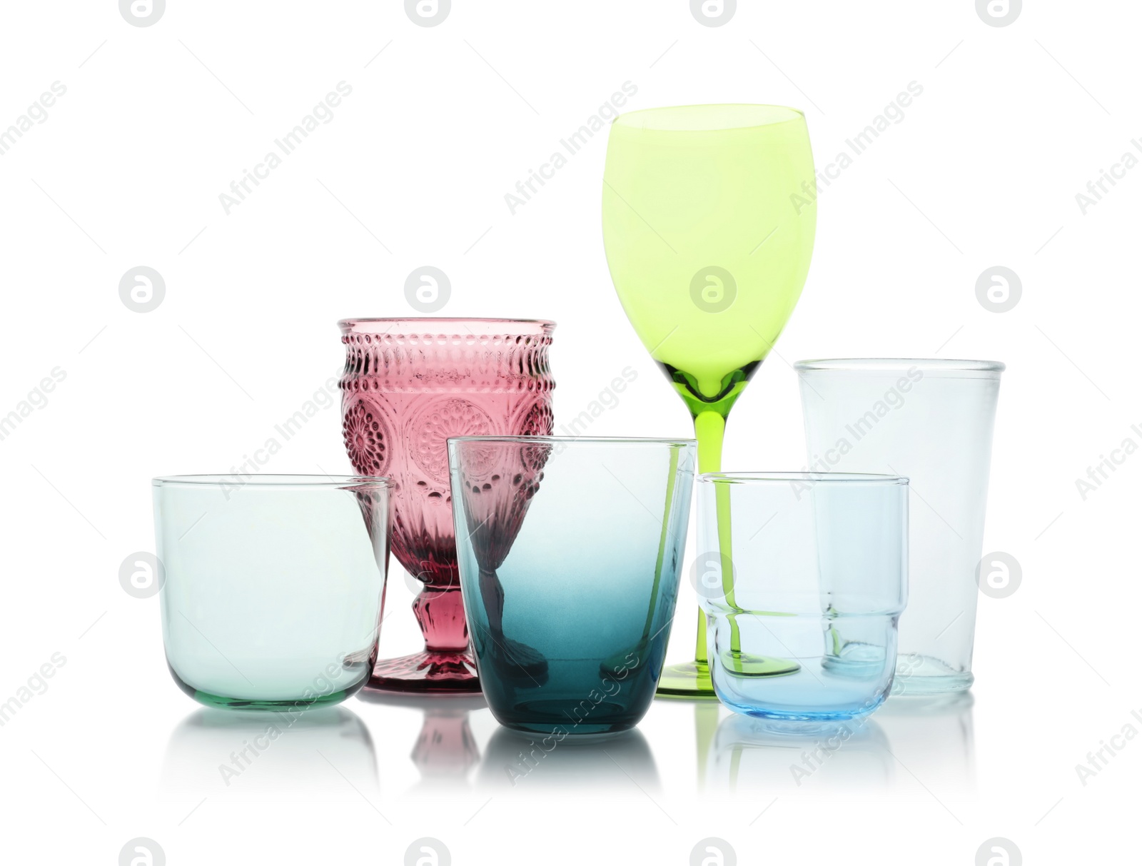 Photo of Set of colorful empty glasses on white background