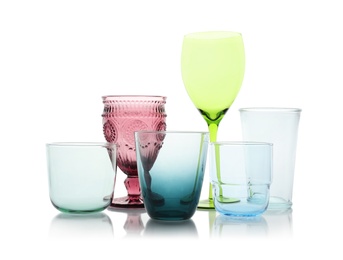 Photo of Set of colorful empty glasses on white background