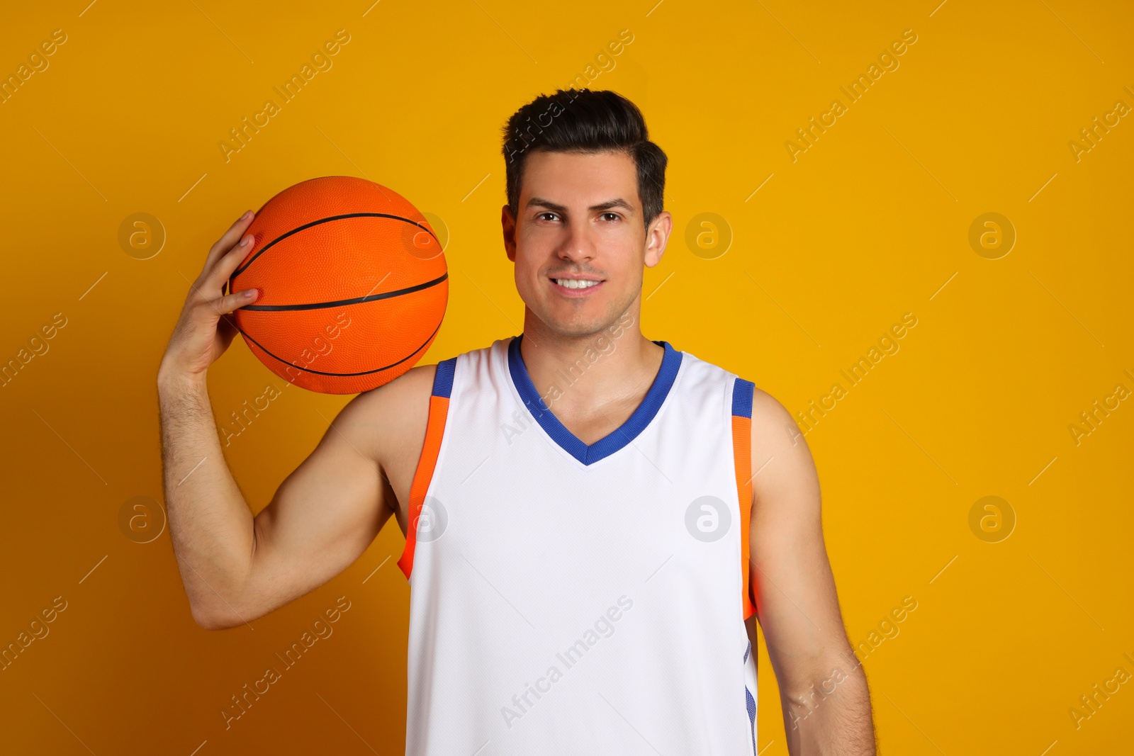 Photo of Basketball player with ball on yellow background