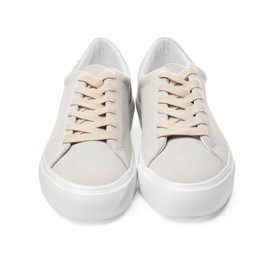 Pair of stylish beige sneakers isolated on white