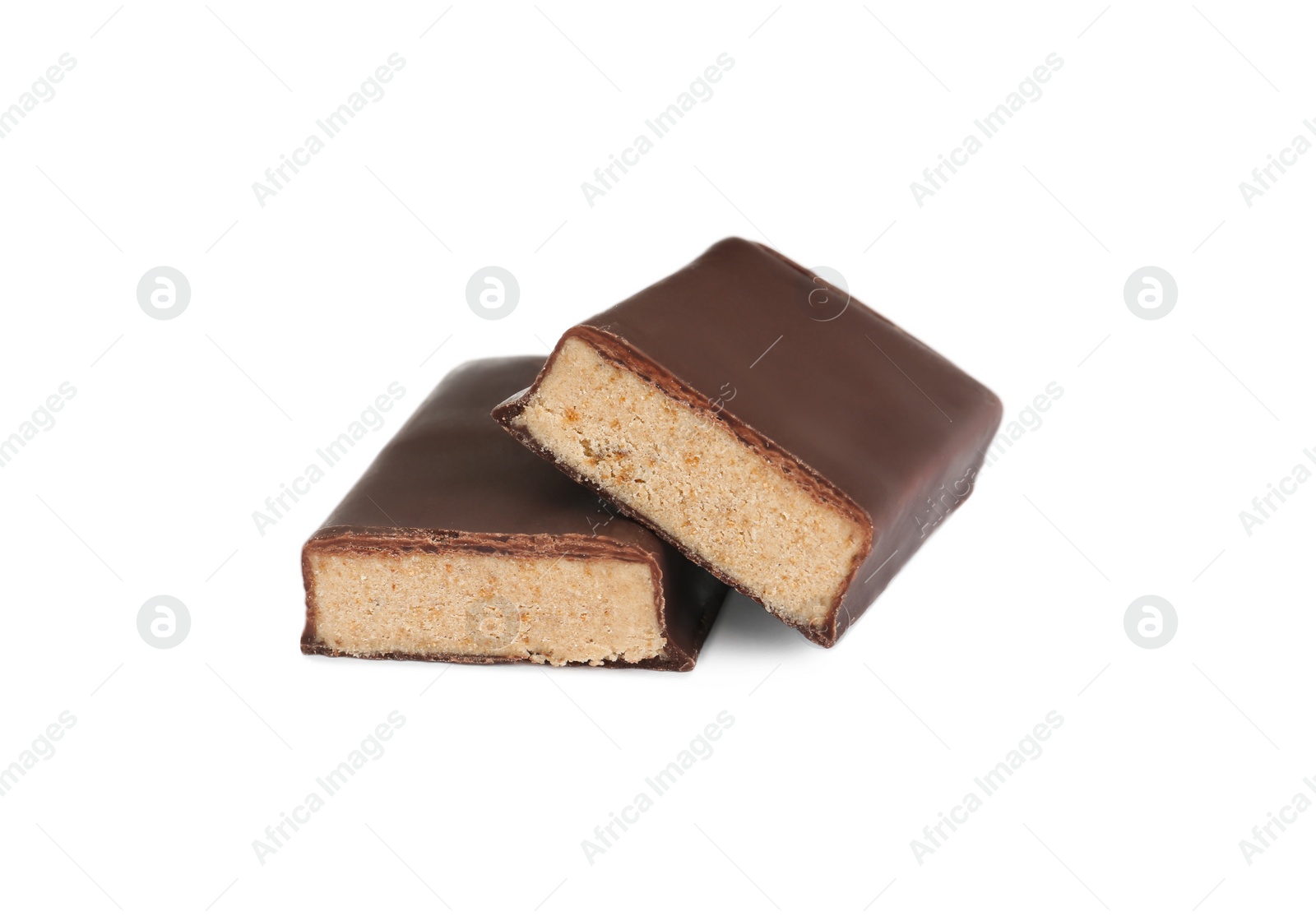 Photo of Halves of tasty chocolate glazed protein bar on white background