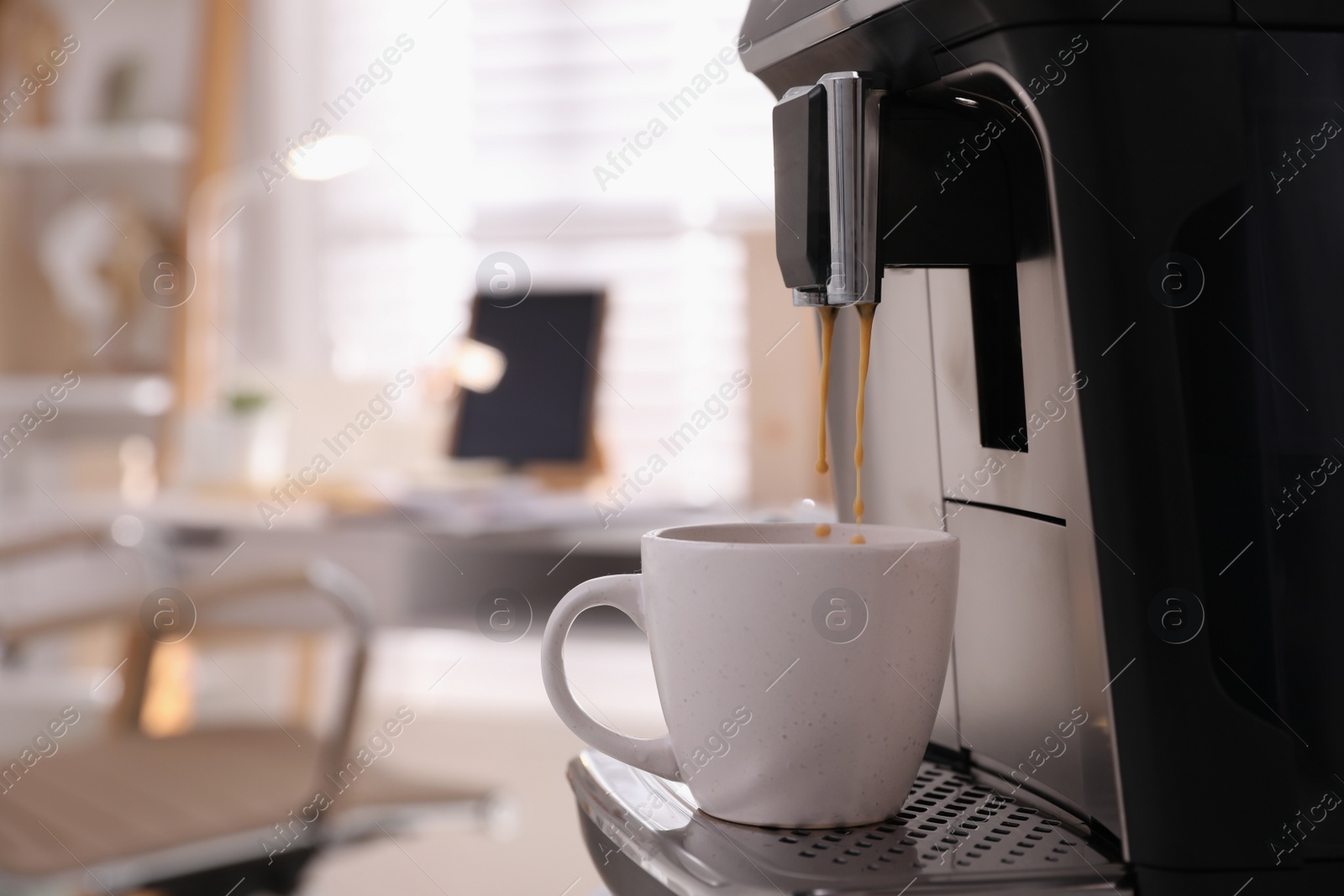 Photo of Modern espresso machine pouring coffee into cup in office. Space for text