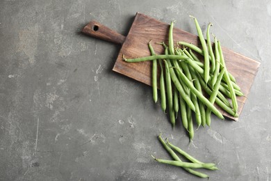 Photo of Fresh green beans on grey table, flat lay. Space for text