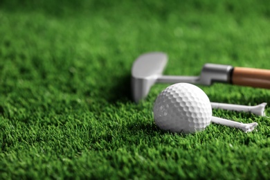 Photo of Set of golf equipment on artificial grass, space for text