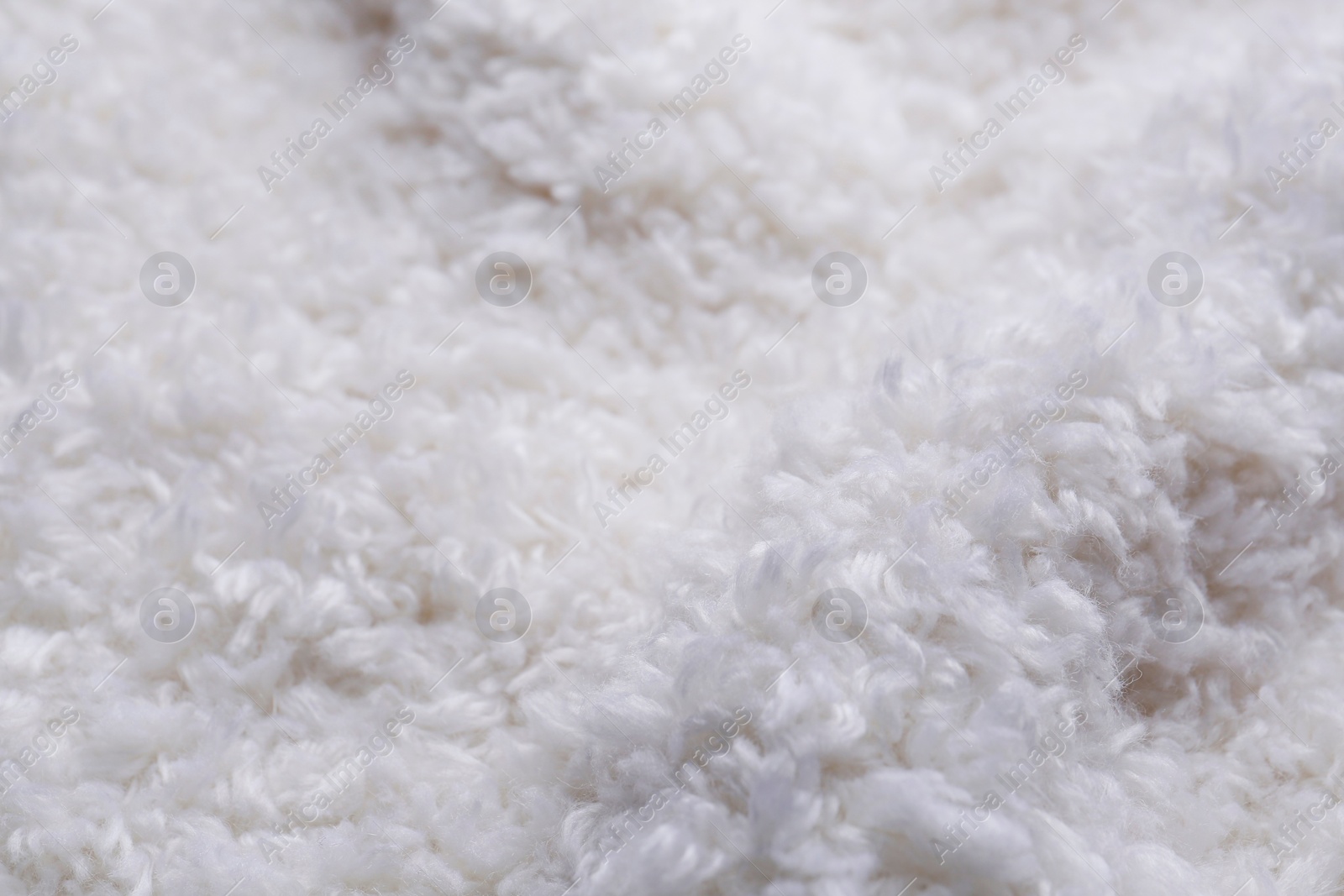 Photo of Soft white knitted fabric as background, closeup